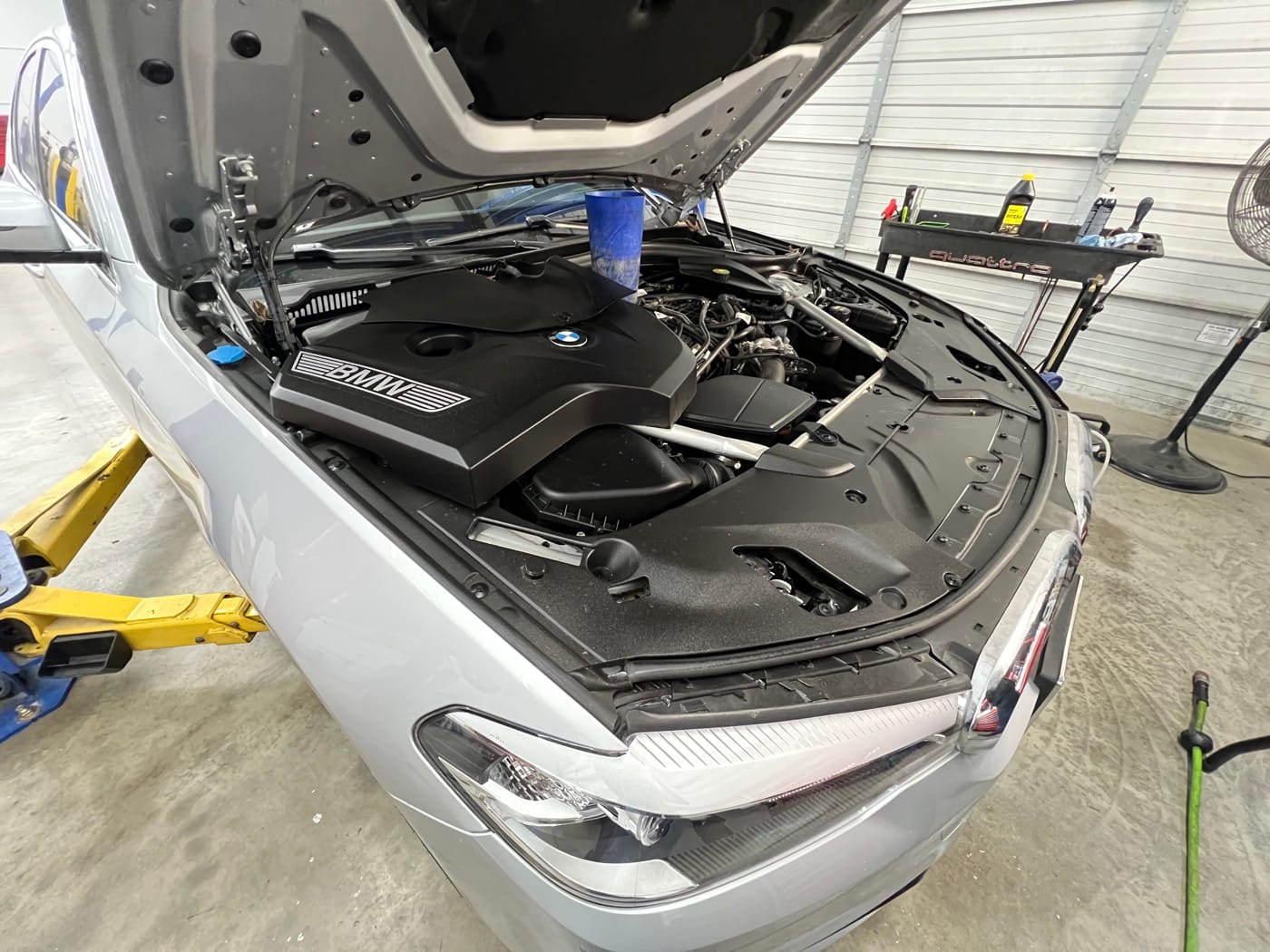 German car engine bay open for an oil leak inspection