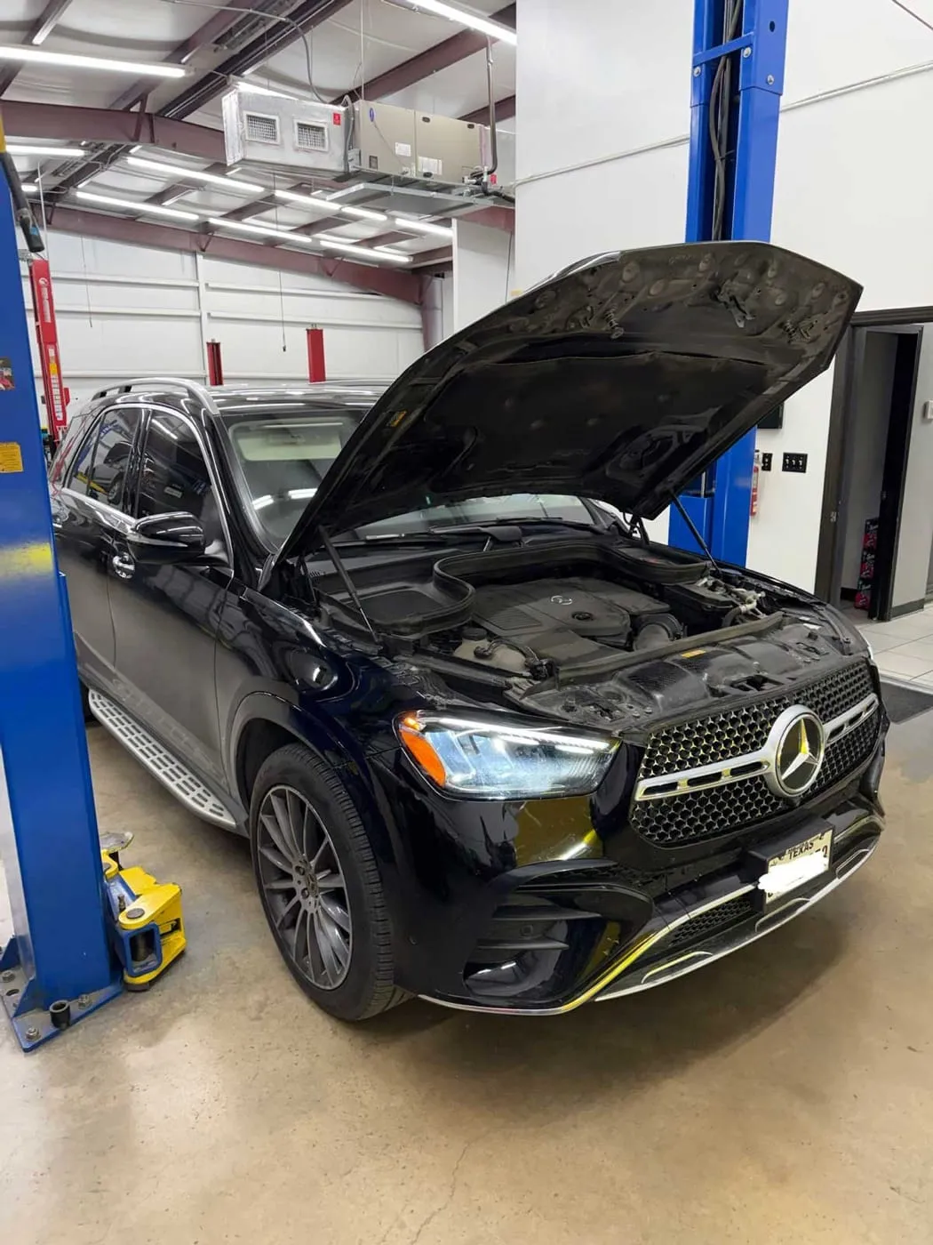 Mercedes GLE on the lift with the hood up for service